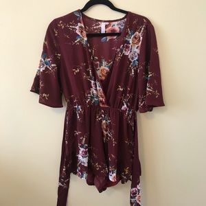 Maroon romper with floral pattern
